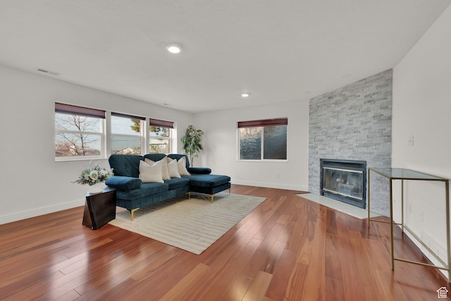 4821 S Fortuna Way, Salt Lake City, UT 84124 - living area featuring baseboards, a fireplace, visible vents, and wood-type flooring