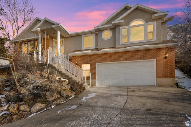 4821 S Fortuna Way, Salt Lake City, UT 84124 - view of front of property featuring an attached garage, stairs, concrete driveway, and brick siding