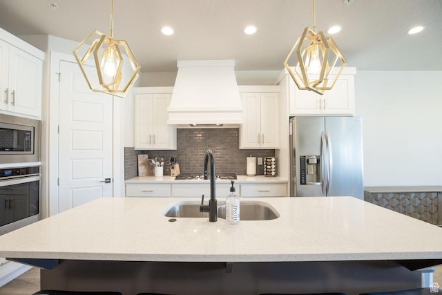 2306 N Park Dr Unit 43, Washington, UT 84780 - kitchen with sink, premium range hood, stainless steel appliances, and a kitchen island with sink