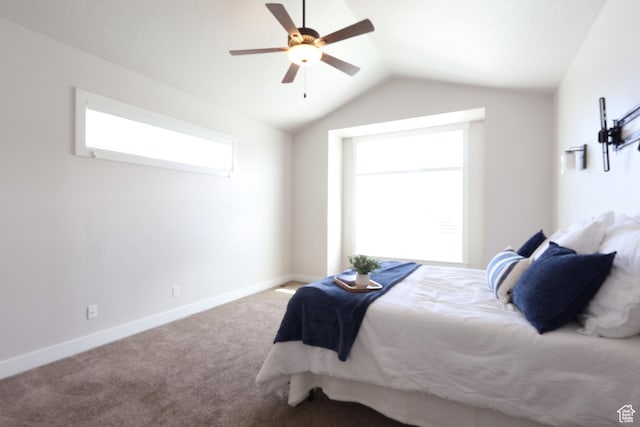 bedroom with carpet flooring, baseboards, a ceiling fan, and lofted ceiling