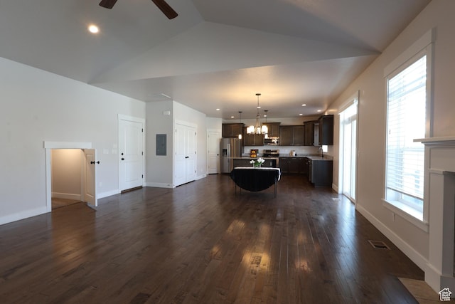 unfurnished living room featuring ceiling fan with notable chandelier, electric panel, visible vents, dark wood-style flooring, and baseboards