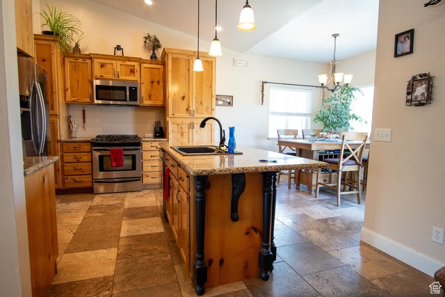159 S 400 E, Annabella, UT 84711 - kitchen featuring appliances with stainless steel finishes, a sink, lofted ceiling, stone tile flooring, and baseboards