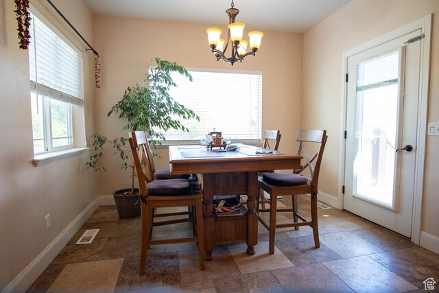 159 S 400 E, Annabella, UT 84711 - dining room featuring a chandelier, baseboards, and light stone finish flooring