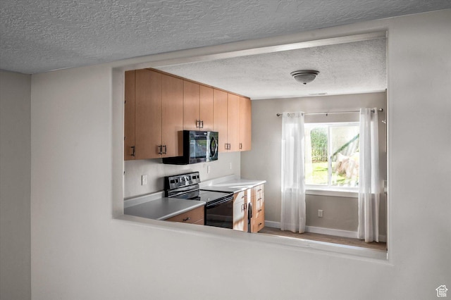 4487 W Tee Box Dr, South Jordan, UT 84009 - kitchen featuring electric range, black microwave, a textured ceiling, baseboards, and light countertops