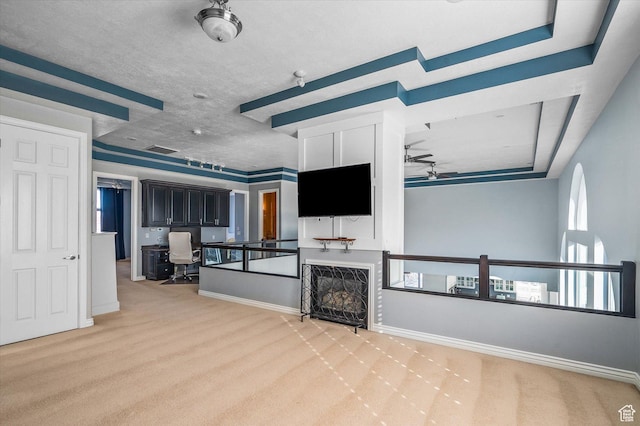 4487 W Tee Box Dr, South Jordan, UT 84009 - unfurnished living room with a ceiling fan, light colored carpet, a desk, and baseboards