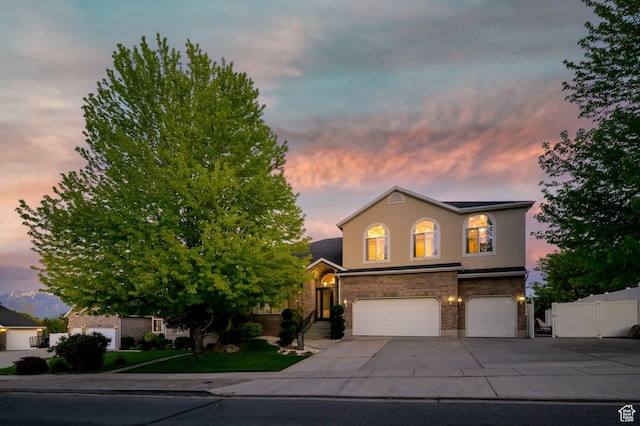 4487 W Tee Box Dr, South Jordan, UT 84009 - view of front of property featuring an attached garage, driveway, and stucco siding