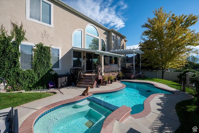 4487 W Tee Box Dr, South Jordan, UT 84009 - view of swimming pool with a pergola, a wooden deck, a pool with connected hot tub, and a patio area