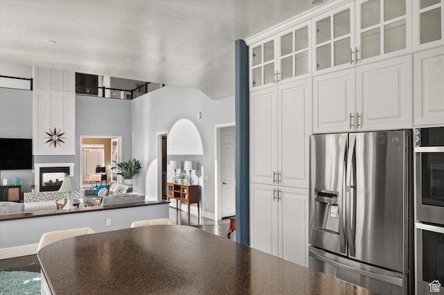 4487 W Tee Box Dr, South Jordan, UT 84009 - kitchen with appliances with stainless steel finishes, dark countertops, open floor plan, and white cabinetry