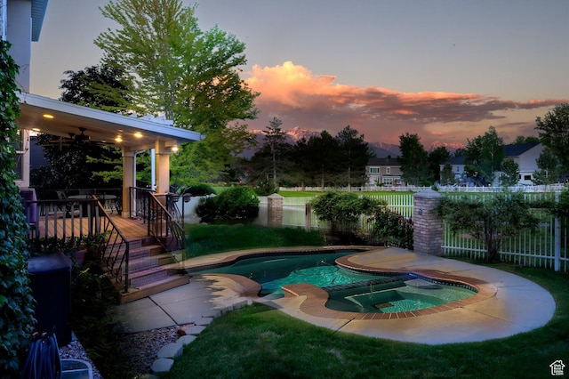 4487 W Tee Box Dr, South Jordan, UT 84009 - pool at dusk featuring a pool with connected hot tub