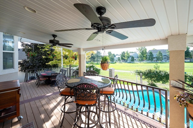 4487 W Tee Box Dr, South Jordan, UT 84009 - wooden deck with outdoor dining space, ceiling fan, and a lawn