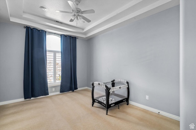 4487 W Tee Box Dr, South Jordan, UT 84009 - living area with carpet floors, ceiling fan, a raised ceiling, and baseboards