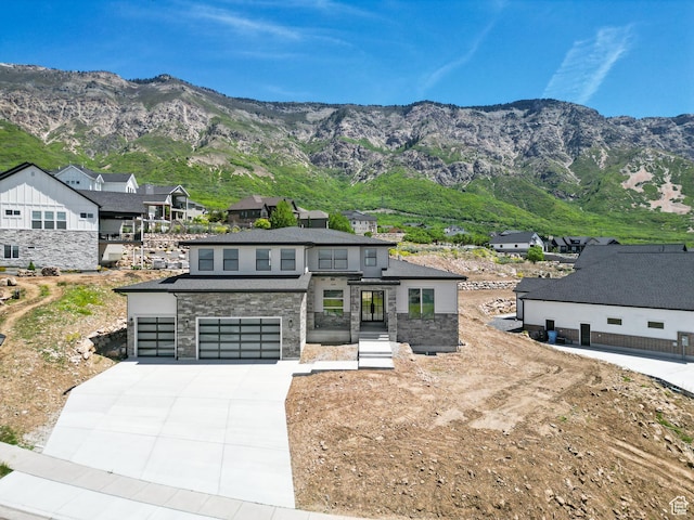 4094 N Jackson Ave, North Ogden, UT 84414 - view of front facade with concrete driveway, stone siding, a garage, and a mountain view