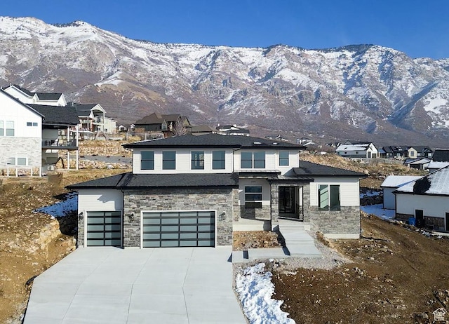 view of front facade featuring a mountain view and a garage