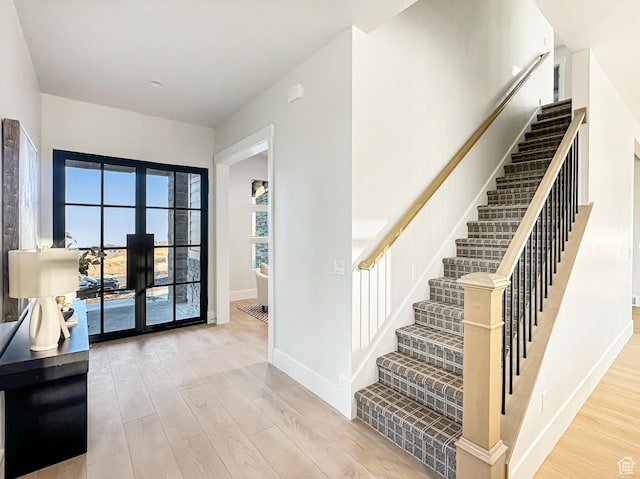 interior space with french doors and light hardwood / wood-style flooring