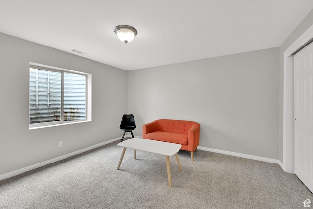living area with baseboards, carpet floors, and visible vents