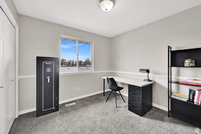 office space featuring baseboards, visible vents, and carpet