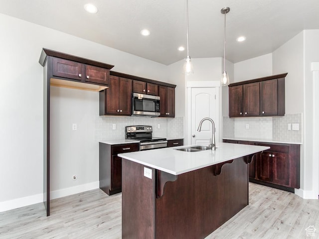 16297 S Truss Dr Unit 614, Bluffdale, UT 84065 - kitchen featuring stainless steel appliances, sink, decorative light fixtures, a center island with sink, and light hardwood / wood-style floors