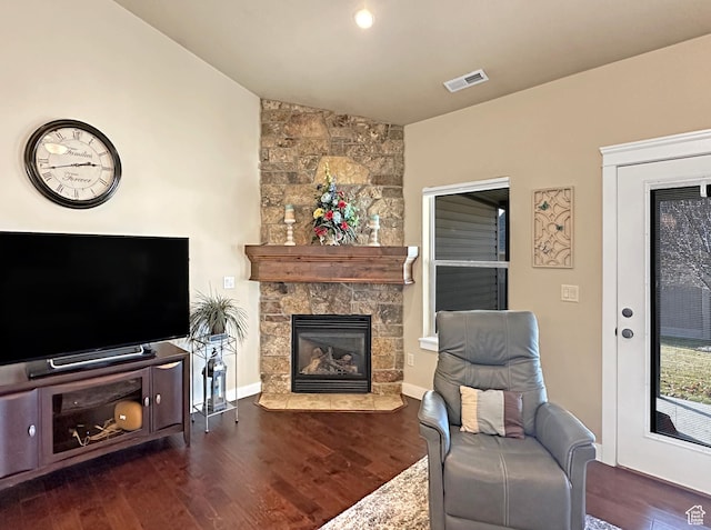 1313 N 250 E, Brigham City, UT 84302 - living room featuring wood finished floors, a fireplace, vaulted ceiling, and baseboards