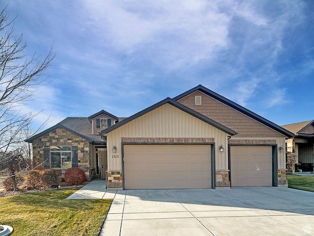1313 N 250 E, Brigham City, UT 84302 - view of front facade featuring a garage, stone siding, concrete driveway, and a front yard
