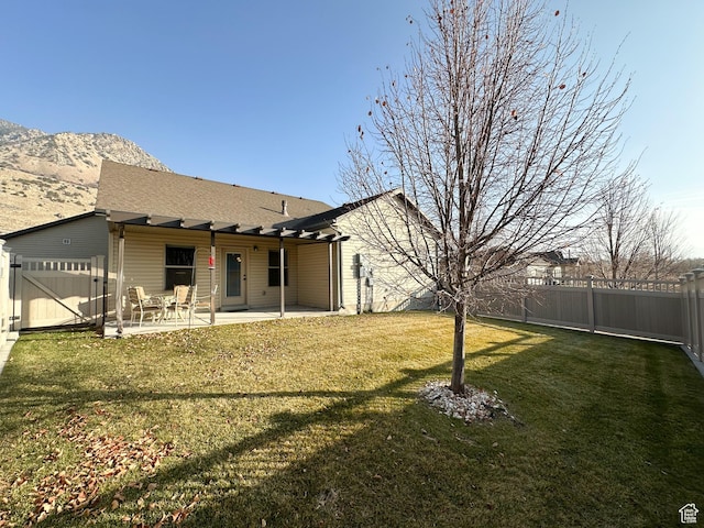 1313 N 250 E, Brigham City, UT 84302 - rear view of property with a patio area, a gate, a mountain view, and a shingled roof