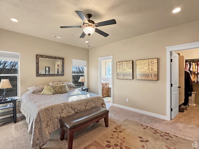 1313 N 250 E, Brigham City, UT 84302 - bedroom featuring light colored carpet, a walk in closet, baseboards, a textured ceiling, and connected bathroom