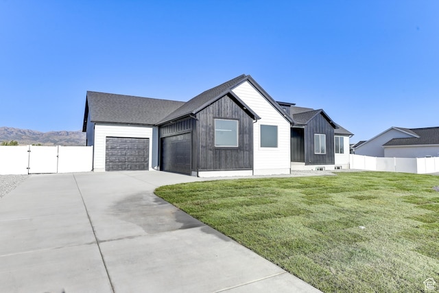 788 S Cedar Rd Unit 106, Grantsville, UT 84029 - modern farmhouse style home with a front yard, a mountain view, and a garage