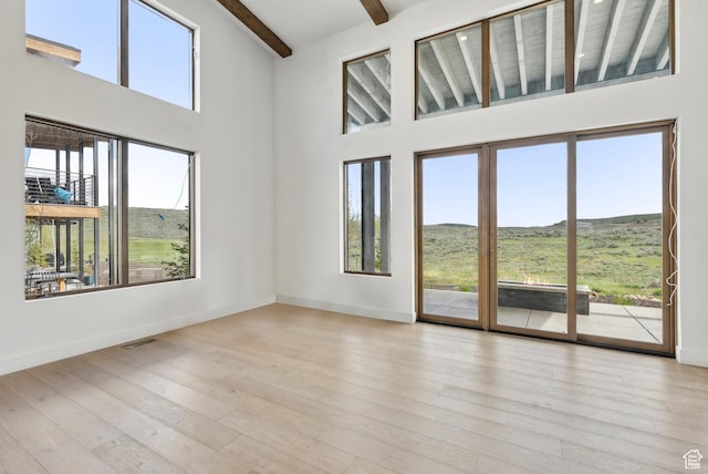 5758 Cobalt Cir Unit 12, Park City, UT 84098 - unfurnished room featuring beamed ceiling, a high ceiling, wood finished floors, baseboards, and a mountain view