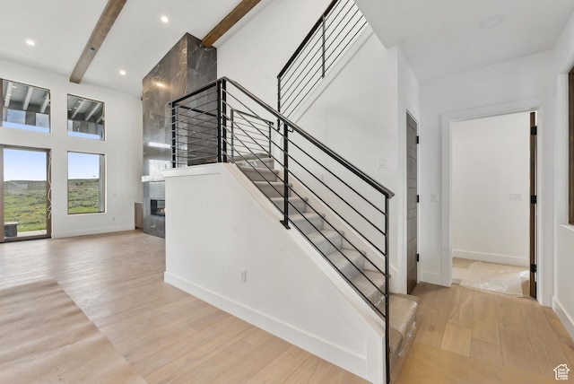5758 Cobalt Cir Unit 12, Park City, UT 84098 - stairway with a fireplace, wood finished floors, baseboards, beam ceiling, and recessed lighting