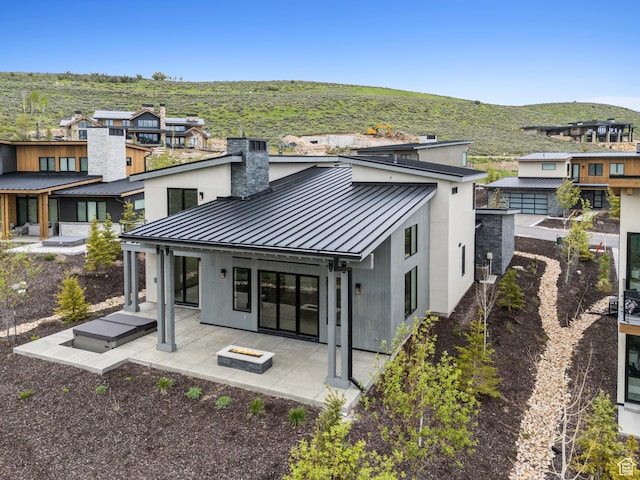 5758 Cobalt Cir Unit 12, Park City, UT 84098 - rear view of house with a standing seam roof, metal roof, a patio, and a chimney