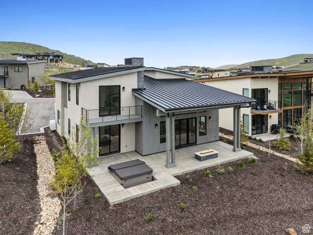5758 Cobalt Cir Unit 12, Park City, UT 84098 - rear view of property with a balcony, a standing seam roof, a patio, metal roof, and a mountain view