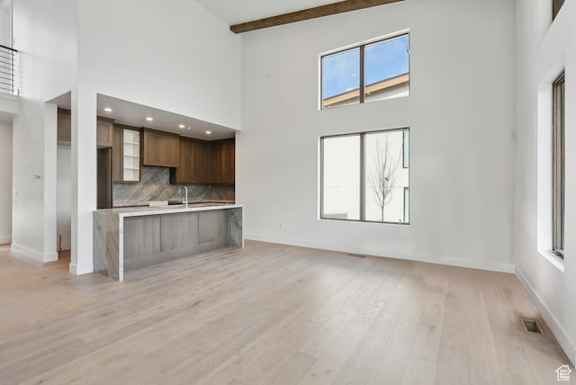 5758 Cobalt Cir Unit 12, Park City, UT 84098 - kitchen featuring a high ceiling, baseboards, light countertops, backsplash, and beam ceiling