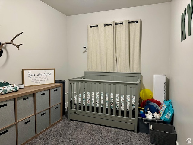bedroom with dark carpet and a nursery area