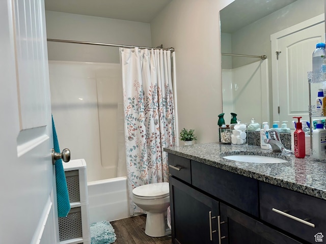 full bathroom featuring vanity, hardwood / wood-style flooring, toilet, and shower / bath combo with shower curtain