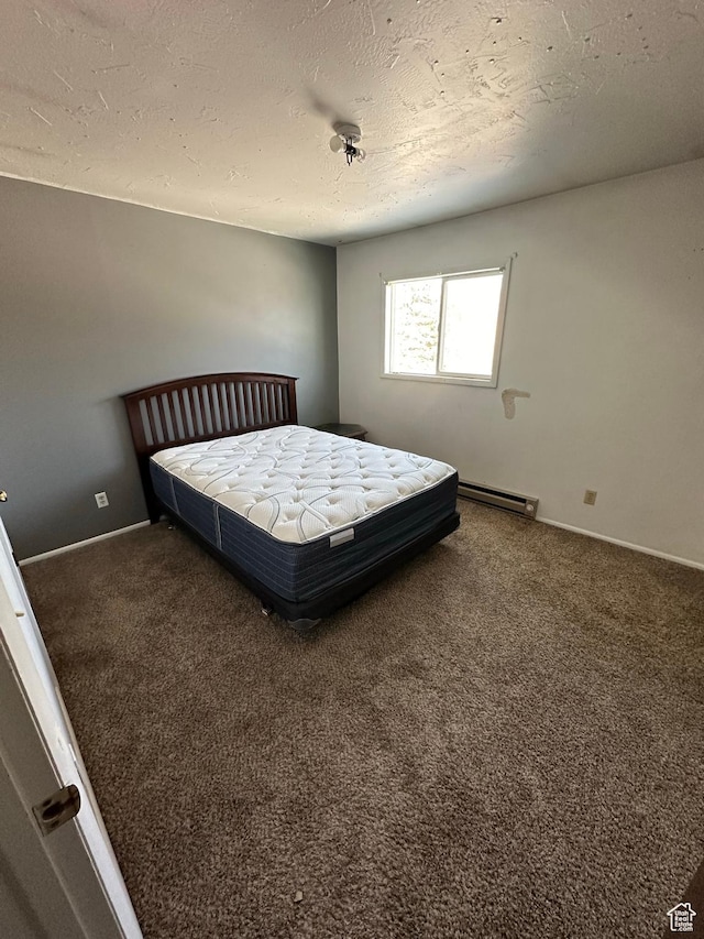 555 N 9th St, Montpelier, ID 83254 - bedroom with carpet floors, a baseboard radiator, a textured ceiling, and baseboards