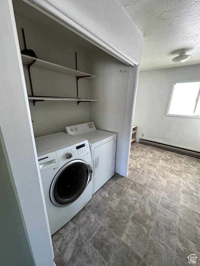 555 N 9th St, Montpelier, ID 83254 - clothes washing area featuring washing machine and dryer, baseboard heating, and a textured ceiling