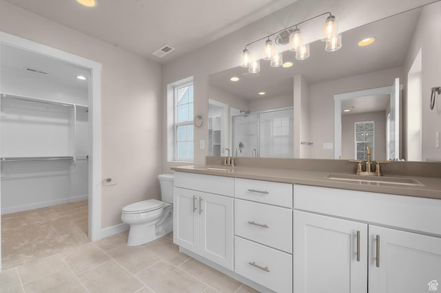 bathroom with visible vents, a stall shower, toilet, and a sink