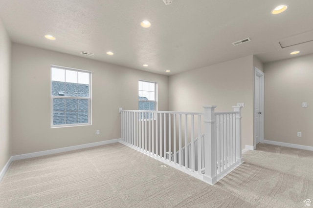 unfurnished room featuring recessed lighting, visible vents, baseboards, and carpet