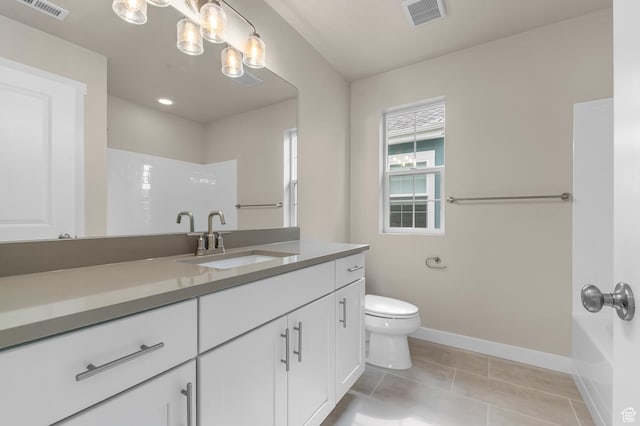 bathroom featuring tile patterned floors, visible vents, toilet, and baseboards