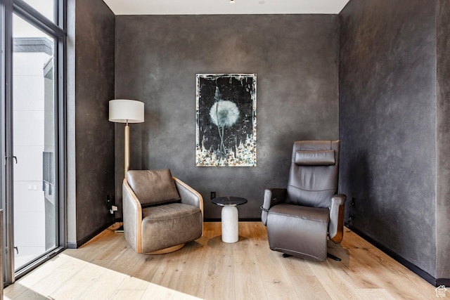sitting room with wood finished floors and baseboards