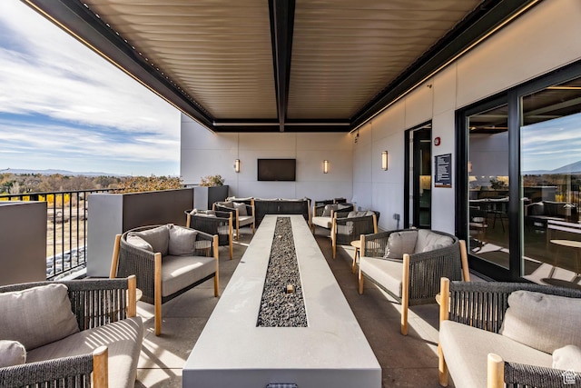 exterior space featuring a balcony and an outdoor hangout area