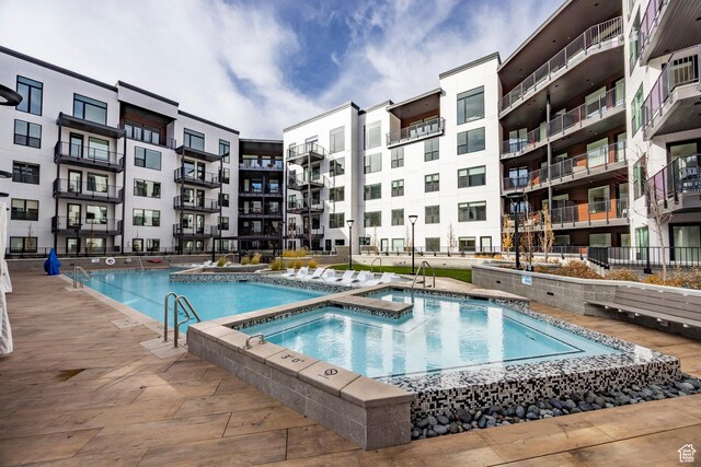view of swimming pool featuring a hot tub