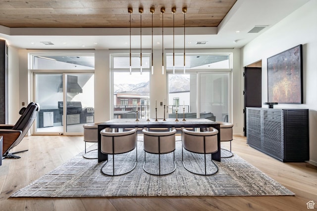 dining area with visible vents and light wood-style flooring