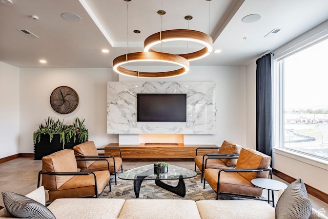 living area with recessed lighting, visible vents, and baseboards
