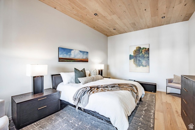 bedroom with wood ceiling, baseboards, and wood finished floors