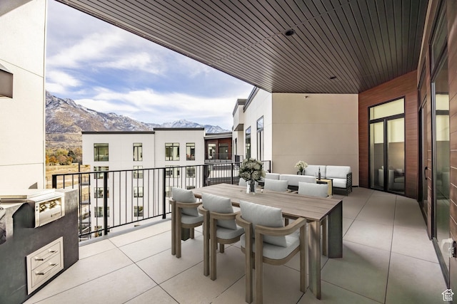exterior space with a mountain view, outdoor lounge area, and a balcony