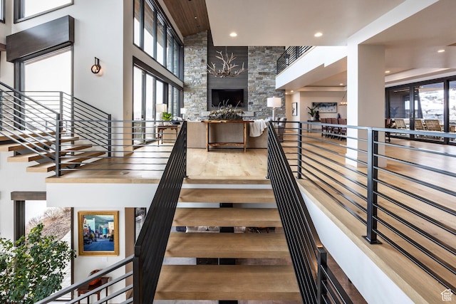 2848 W Deer Pointe Dr, Park City, UT 84060 - stairs with a towering ceiling, a fireplace, and recessed lighting