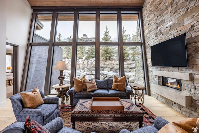 2848 W Deer Pointe Dr, Park City, UT 84060 - living area with a stone fireplace, healthy amount of natural light, and wood finished floors