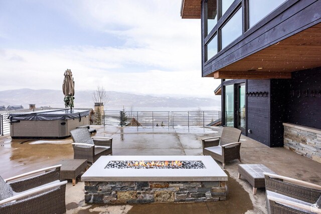 2848 W Deer Pointe Dr, Park City, UT 84060 - view of patio featuring a fire pit, a hot tub, and a mountain view