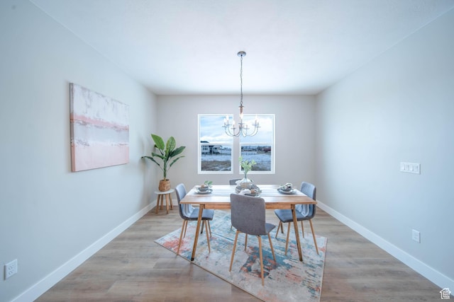 1436 E Parker Ln Unit 426, Lake Point, UT 84074 - dining space featuring an inviting chandelier, wood finished floors, and baseboards