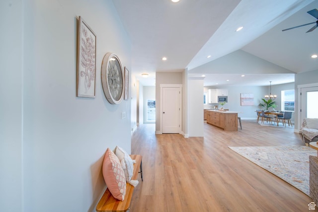 1436 E Parker Ln Unit 426, Lake Point, UT 84074 - corridor featuring vaulted ceiling, baseboards, recessed lighting, a notable chandelier, and light wood-style floors
